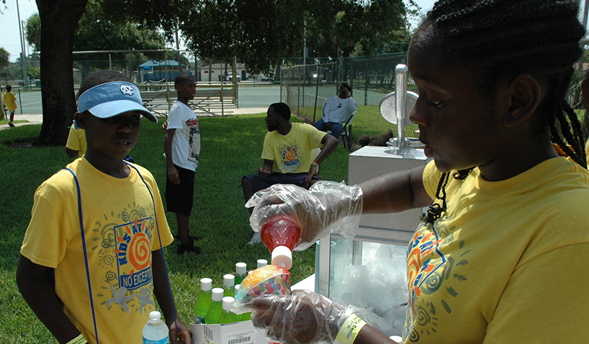 Girl making a snow cone at Lincoln Park Community Center