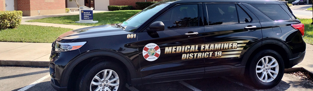 Black SUV with Florida Flag and Medical Examiner District 19 decal