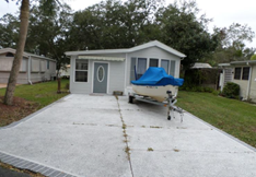 home with one boat in driveway