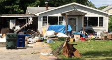 House with outside storage, junk, and debris