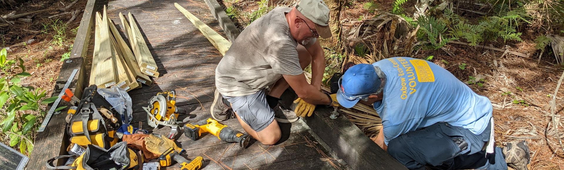 Volunteers repairing wooden deck