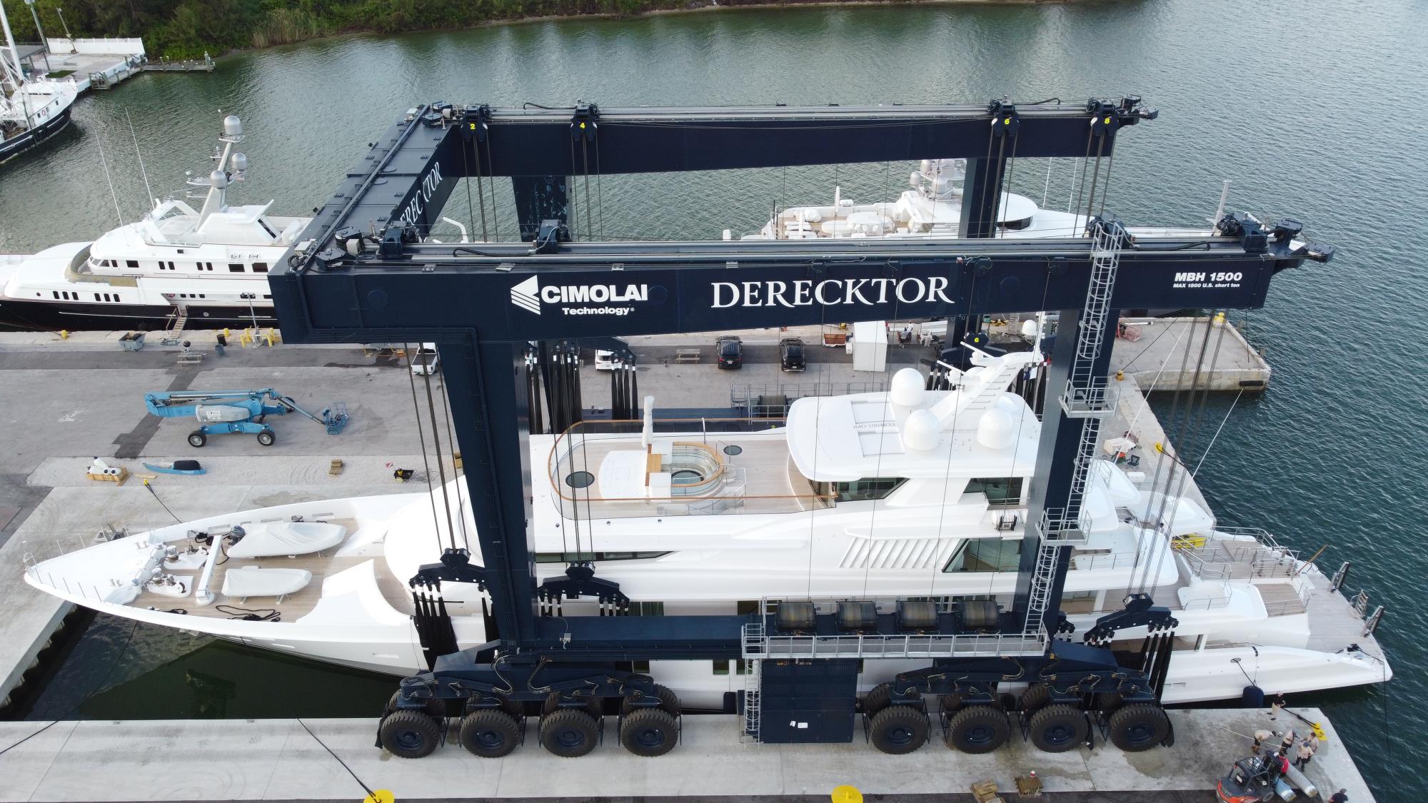 white mega yacht on large boat lift