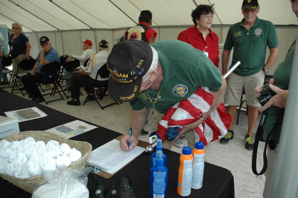 Vietnam Veteran signing a sign-in sheet